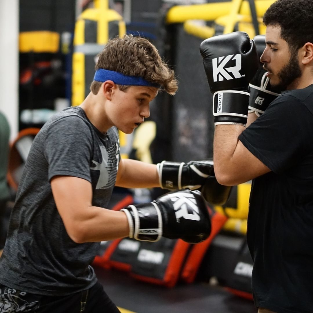 Killer B Combat Academy athletes practicing striking and defensive martial arts techniques.