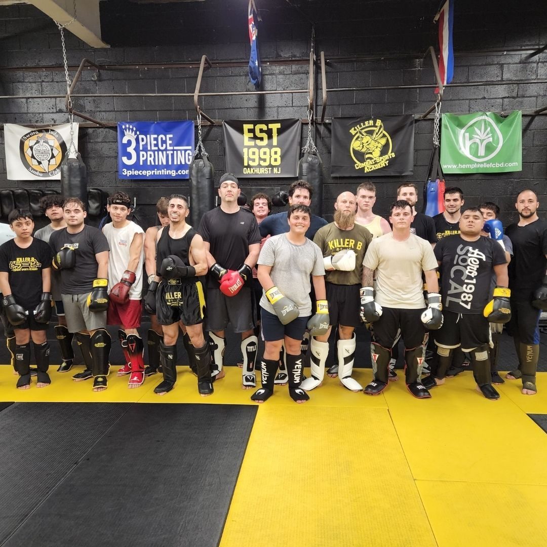 Killer B Combat Academy members participating in hands-on martial arts instruction.