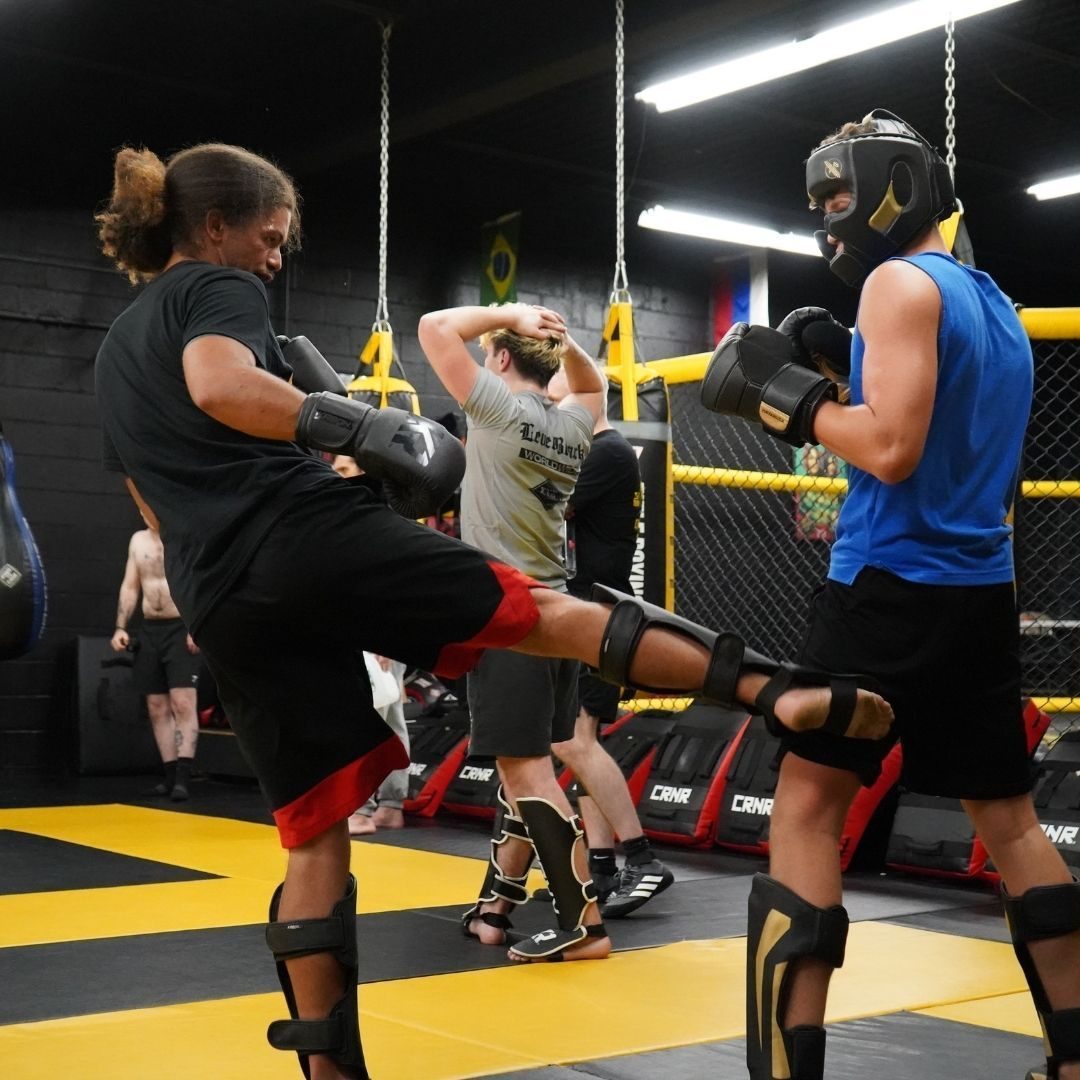 Martial arts instructor coaching students during training at Killer B Combat Academy.